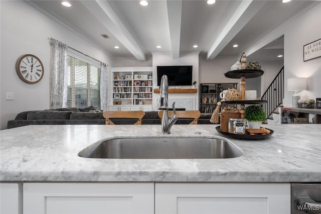 11210 Davis Pl, Northport, AL 35475 - kitchen featuring open floor plan, beamed ceiling, light stone countertops, white cabinetry, and recessed lighting