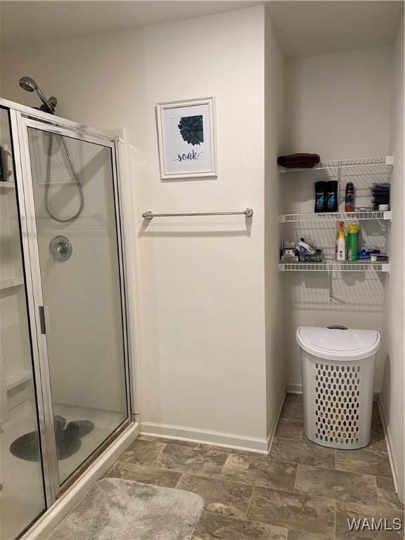 bathroom featuring a shower with shower door