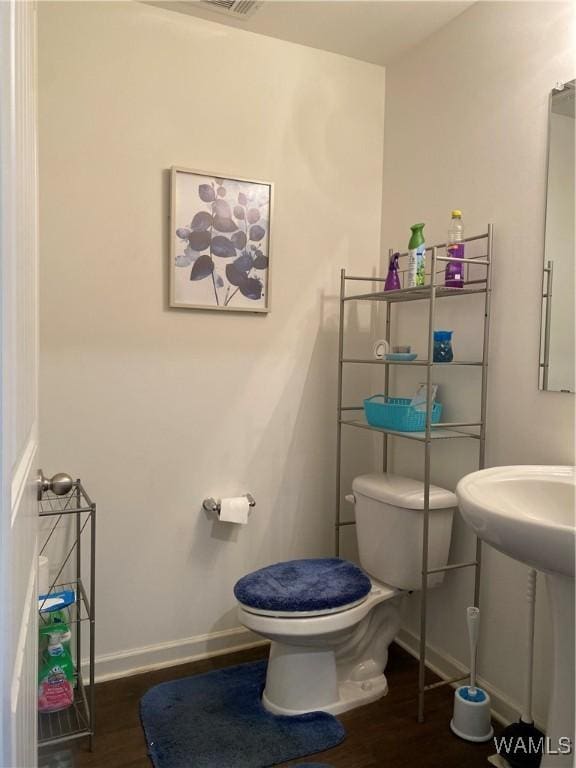 bathroom featuring sink, toilet, and hardwood / wood-style flooring