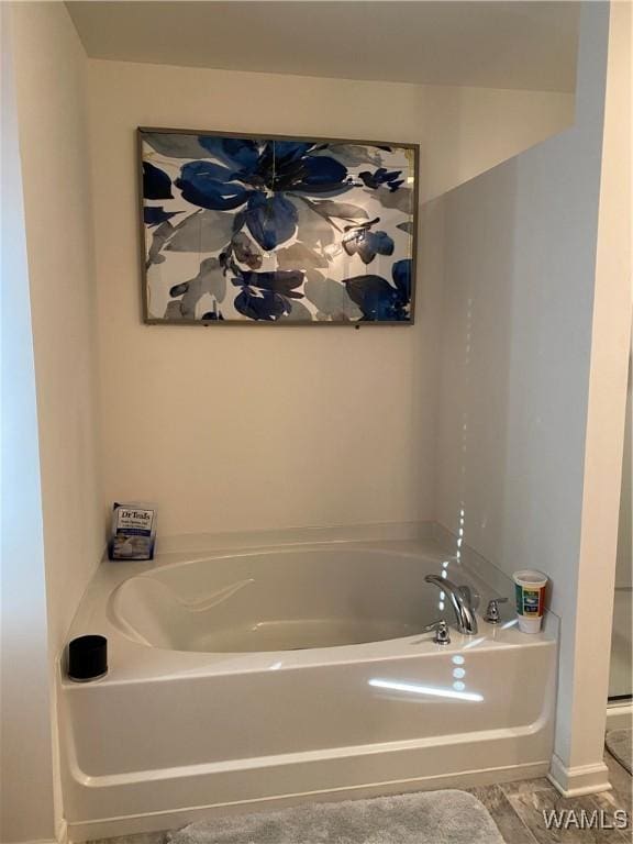 bathroom featuring a tub to relax in