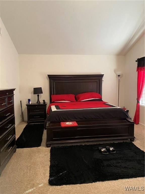 carpeted bedroom featuring vaulted ceiling