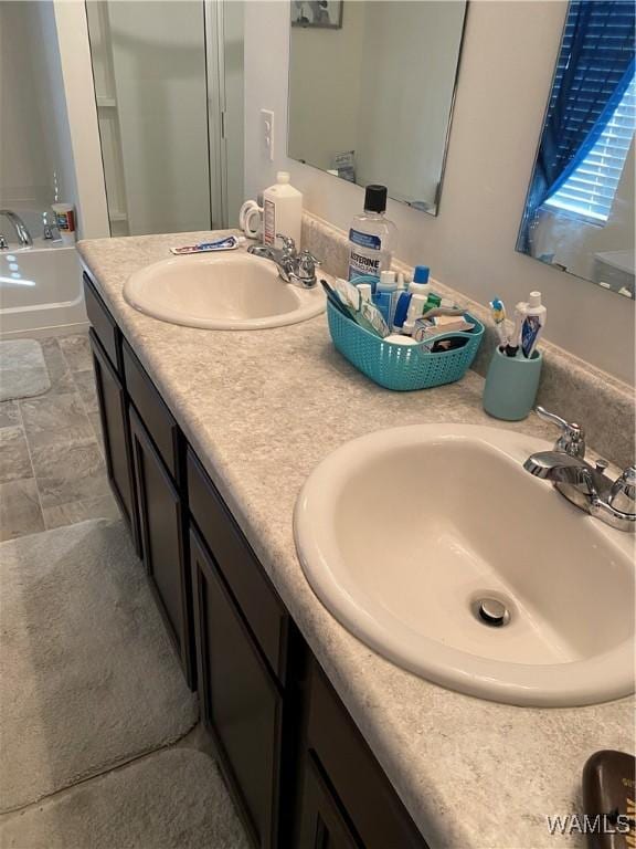 bathroom featuring vanity and a tub