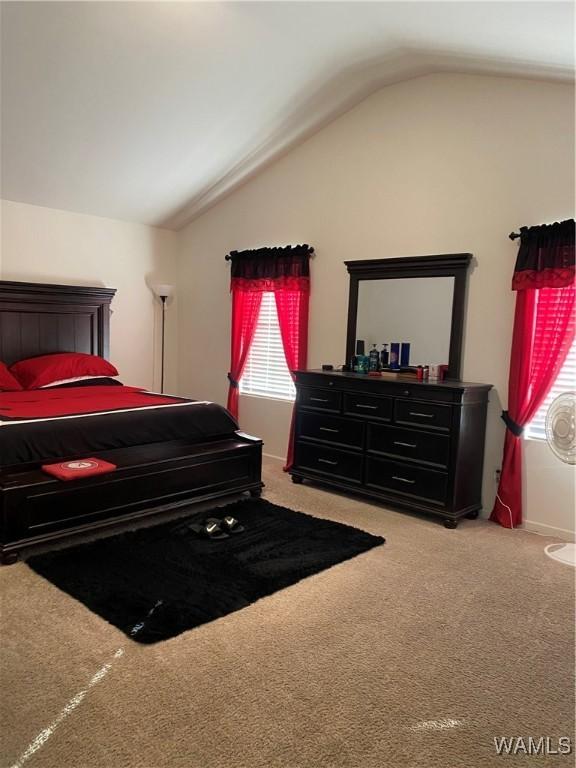 bedroom with carpet and lofted ceiling