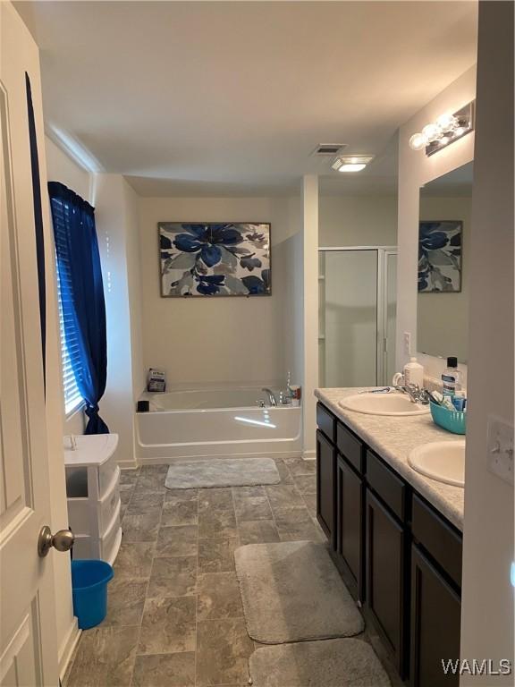 bathroom featuring plus walk in shower and vanity