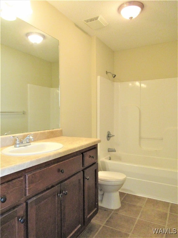 full bathroom with tile patterned floors, vanity, bathtub / shower combination, and toilet