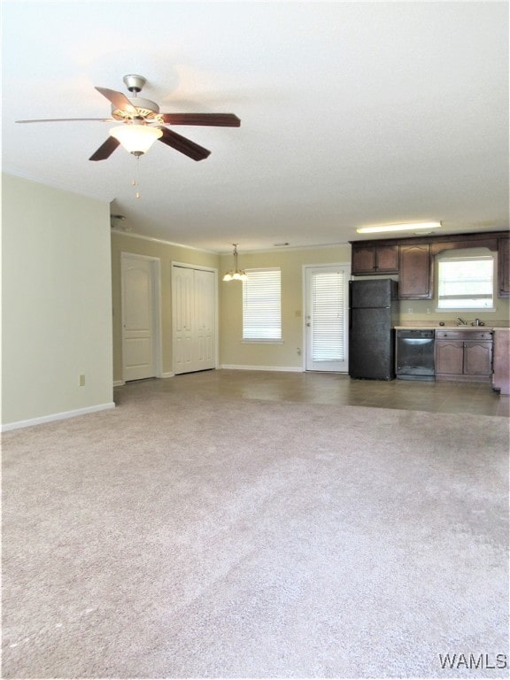 unfurnished living room with carpet flooring and ceiling fan with notable chandelier