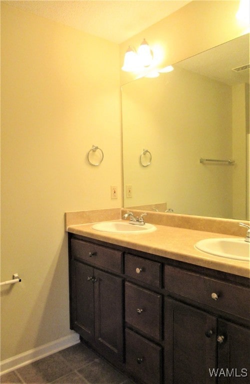 bathroom with tile patterned flooring and vanity