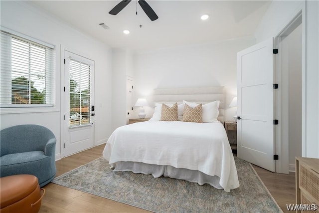 bedroom featuring ceiling fan, light hardwood / wood-style flooring, and access to outside