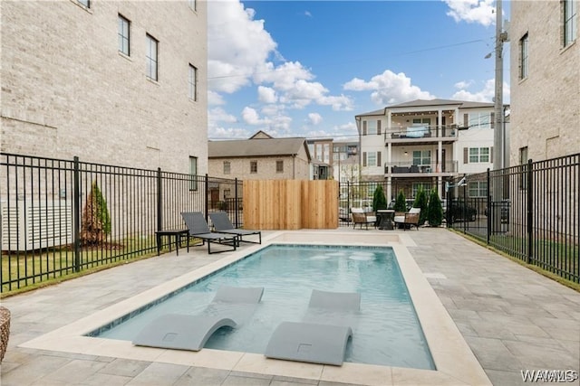 view of swimming pool featuring a patio area