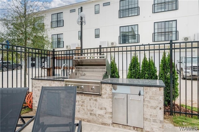 view of patio / terrace with exterior kitchen, sink, and a grill