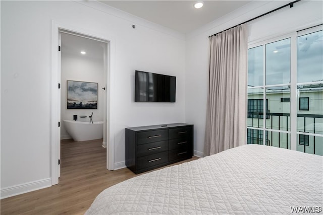 bedroom with light hardwood / wood-style flooring and crown molding