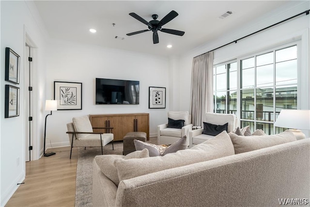 living room featuring ceiling fan and light hardwood / wood-style floors