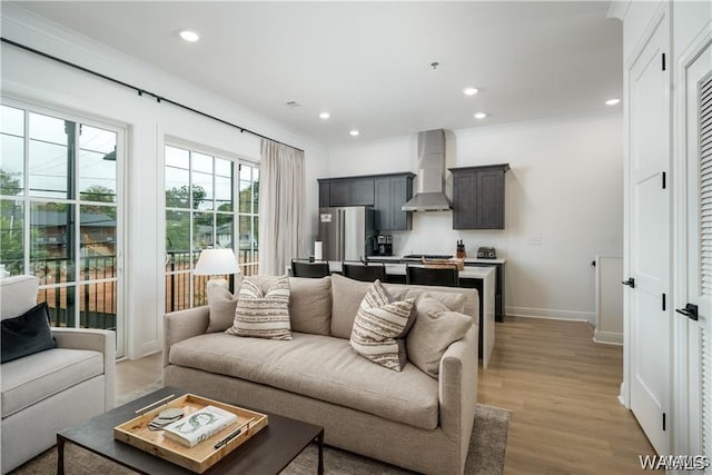 living room featuring light hardwood / wood-style flooring and crown molding