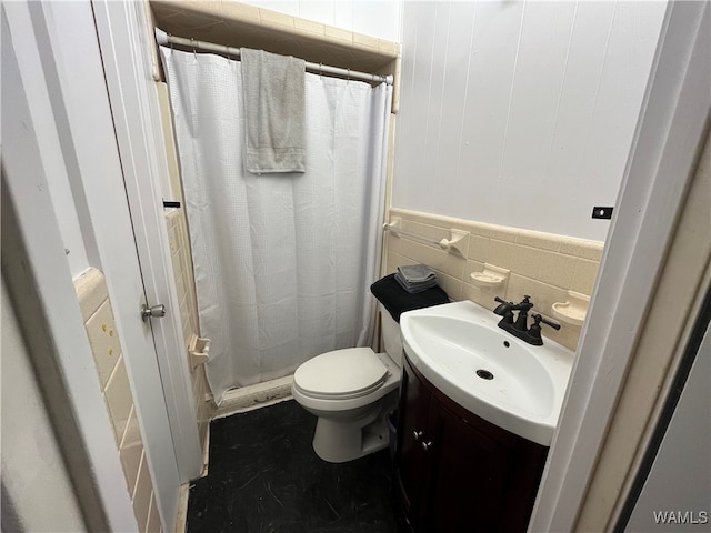 bathroom featuring a shower with shower curtain, vanity, toilet, and tile walls