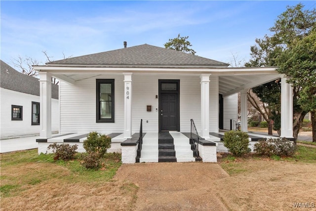 view of front of house with a shingled roof and a porch