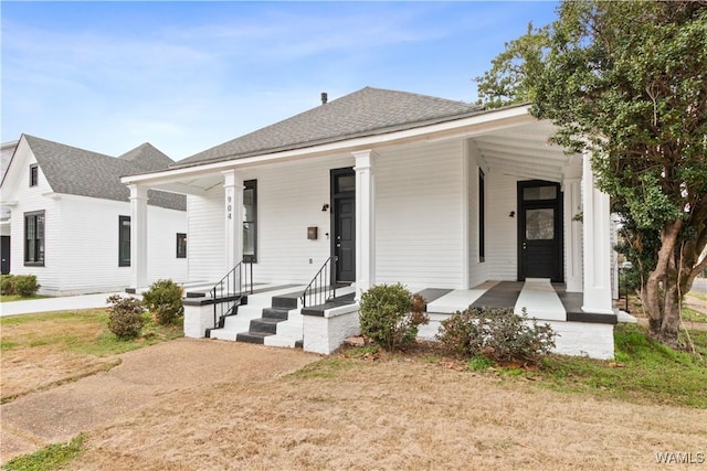 view of front of home featuring covered porch and roof with shingles