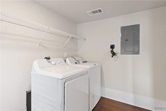 laundry area with dark wood-style floors, visible vents, washer and dryer, laundry area, and electric panel