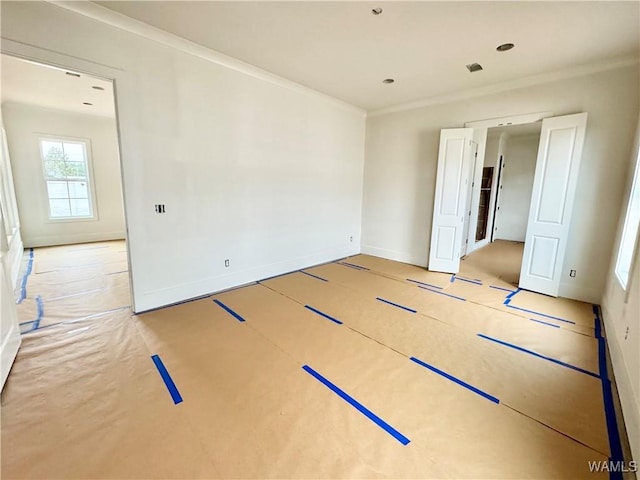 unfurnished room with ornamental molding and basketball hoop