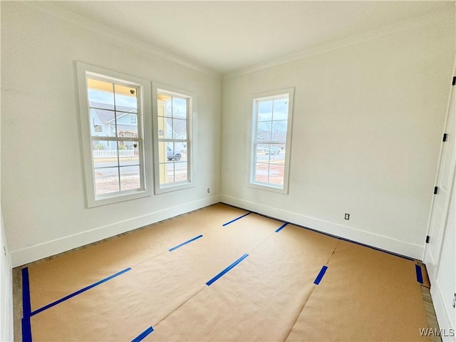 unfurnished room featuring ornamental molding