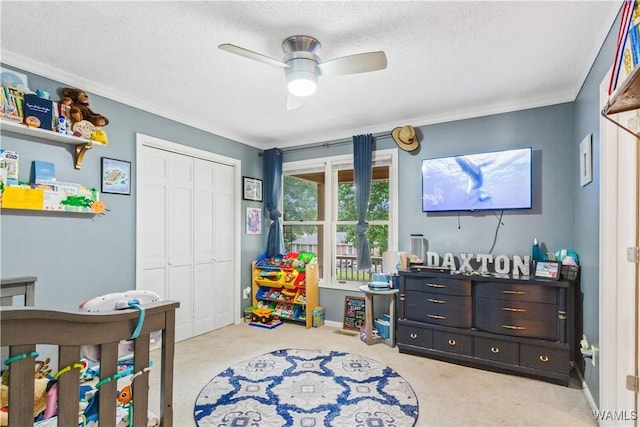 15551 Oakwood Dr, Brookwood, AL 35444 - bedroom with carpet floors, ornamental molding, a textured ceiling, a closet, and a ceiling fan