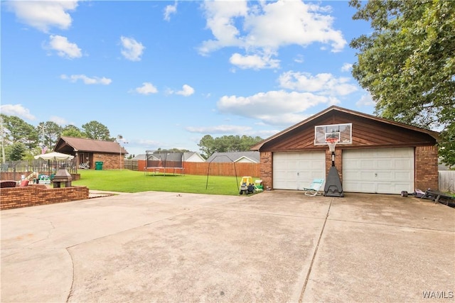 15551 Oakwood Dr, Brookwood, AL 35444 - detached garage featuring a trampoline