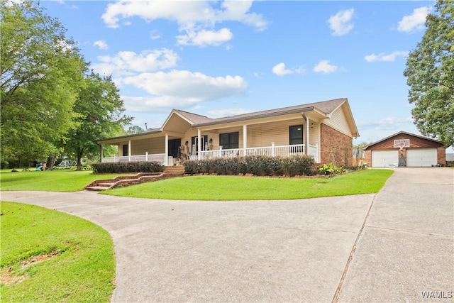 15551 Oakwood Dr, Brookwood, AL 35444 - view of front of house with a porch, a detached garage, an outdoor structure, and a front yard