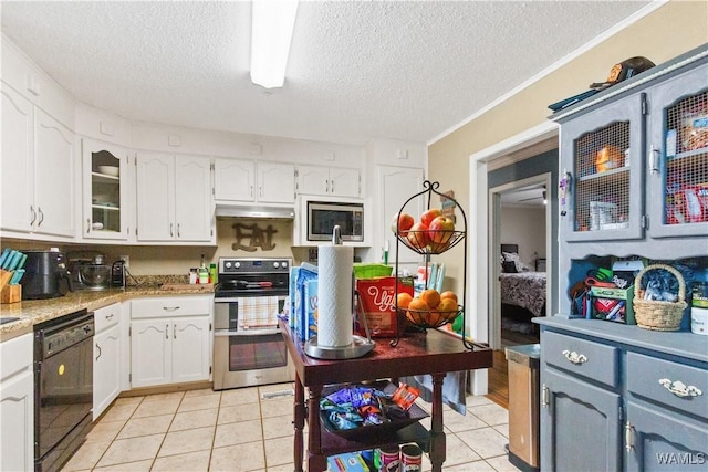 15551 Oakwood Dr, Brookwood, AL 35444 - kitchen with stainless steel appliances, a textured ceiling, white cabinetry, light tile patterned floors, and light countertops