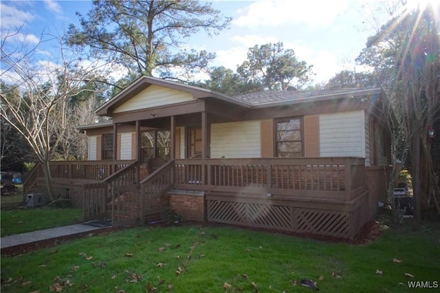 view of front of house with a porch, a front yard, and stairway