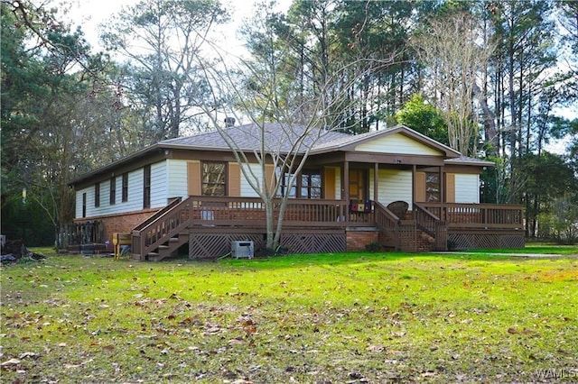 single story home featuring brick siding, stairway, and a front lawn