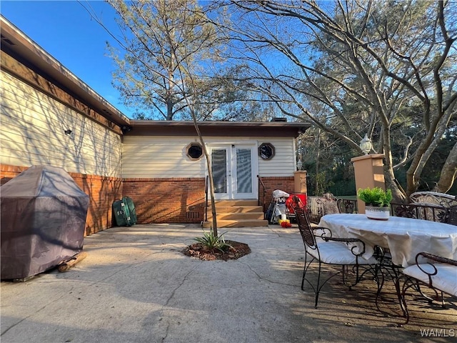 view of patio featuring entry steps, french doors, and fence