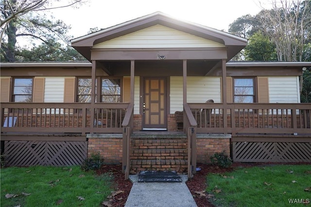 view of front of home featuring a porch and brick siding