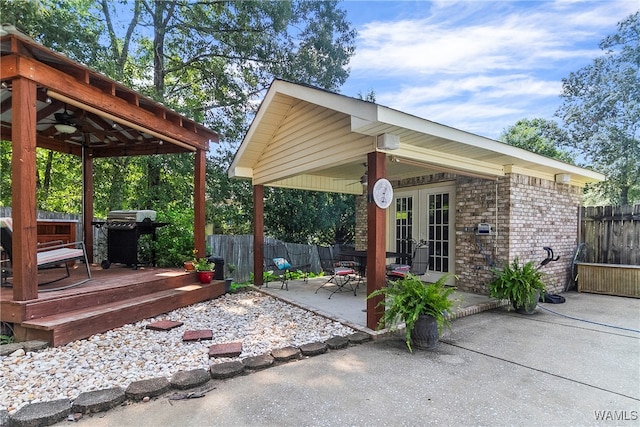 view of patio with area for grilling, a deck, and french doors