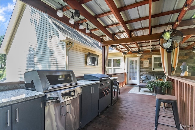 view of patio with area for grilling, ceiling fan, grilling area, and a deck