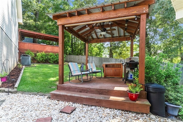 deck featuring a lawn, central AC, ceiling fan, and a grill