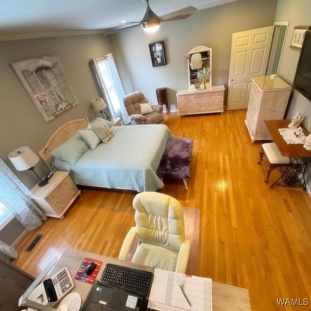 bedroom featuring light wood-type flooring, ceiling fan, and ornamental molding