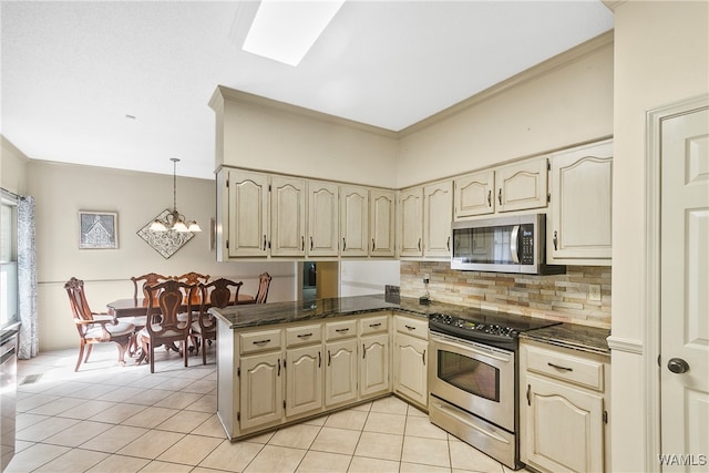 kitchen with kitchen peninsula, hanging light fixtures, light tile patterned floors, and stainless steel appliances