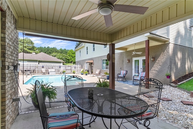 view of patio featuring ceiling fan, a fenced in pool, and french doors