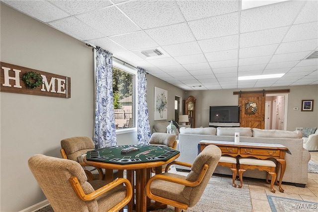 tiled dining room with a paneled ceiling