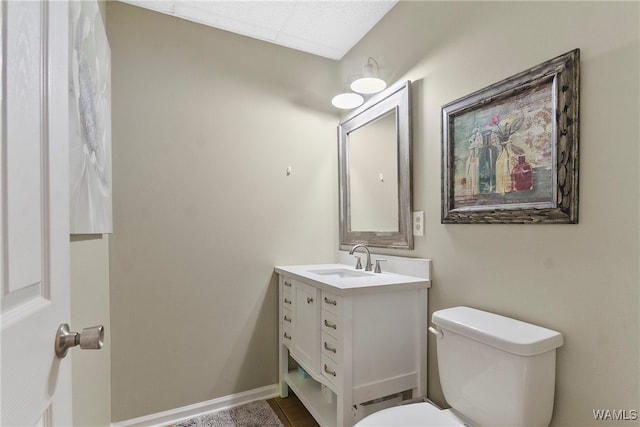 bathroom featuring vanity and toilet