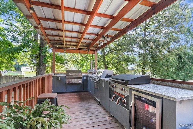 wooden deck featuring area for grilling, grilling area, and wine cooler