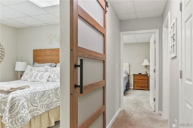 carpeted bedroom with a drop ceiling