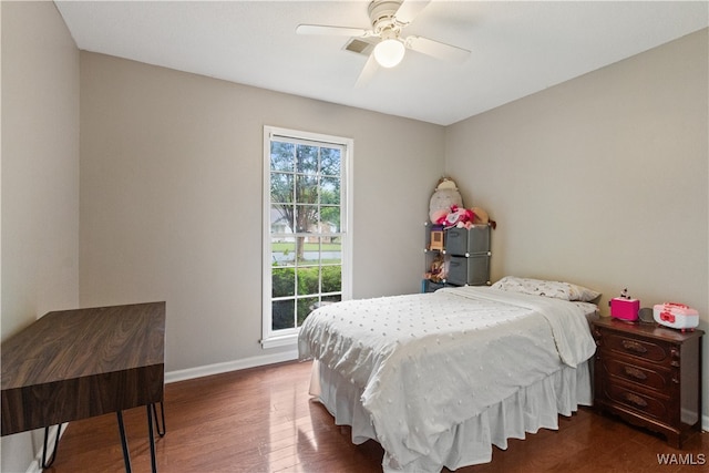 bedroom with ceiling fan and dark hardwood / wood-style flooring