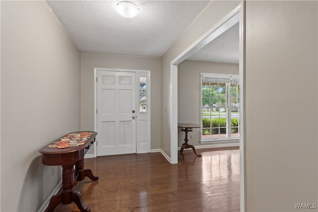 entryway with a textured ceiling and dark hardwood / wood-style floors