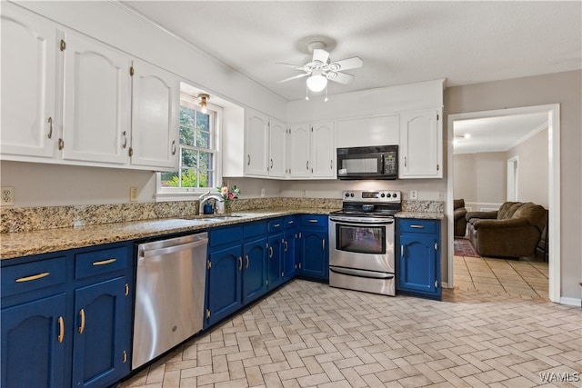 kitchen featuring white cabinetry, sink, ceiling fan, stainless steel appliances, and blue cabinets