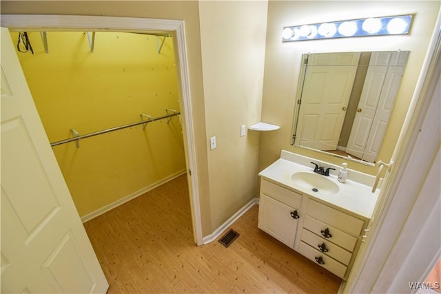 bathroom featuring hardwood / wood-style flooring and vanity