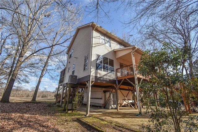 rear view of property featuring a wooden deck