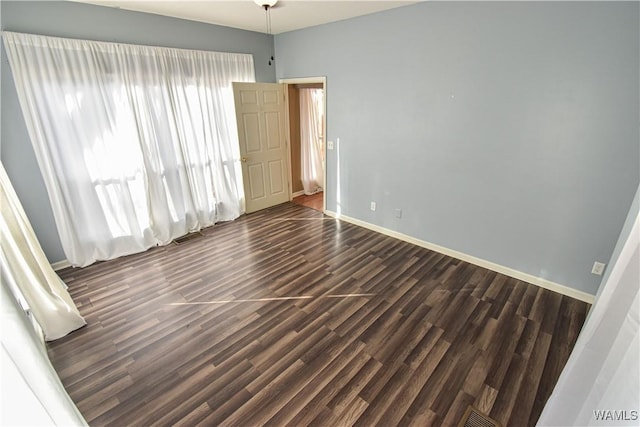 spare room featuring dark hardwood / wood-style floors