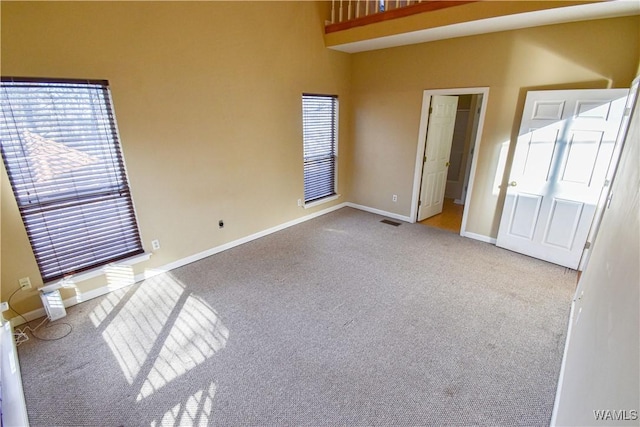 unfurnished room featuring light carpet