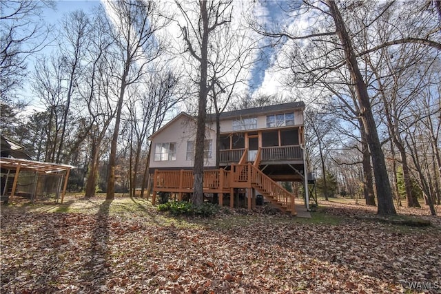 rear view of property with a sunroom