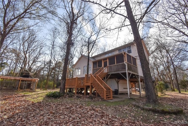 back of property featuring a sunroom